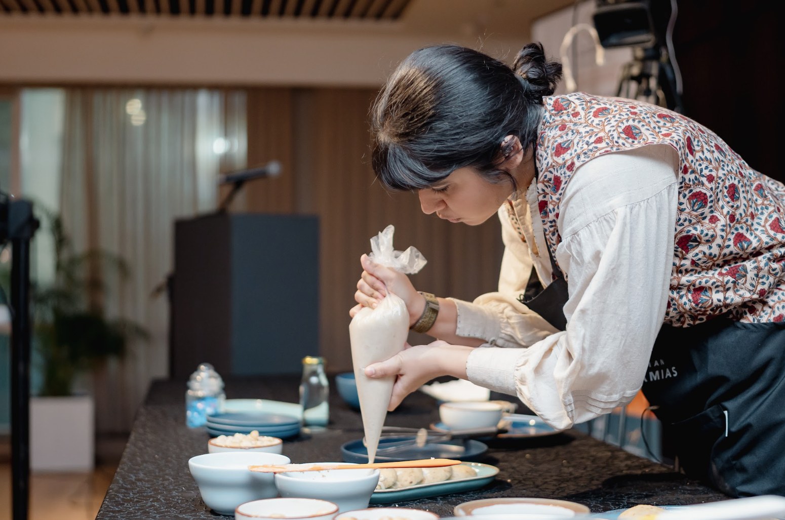 A chef piping a macadamia filling live on stage